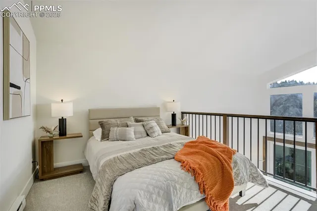 a bedroom with a bed and a large window