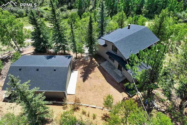 an aerial view of a house with a yard