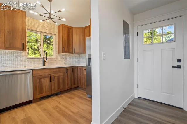 a view of a kitchen with wooden floor and a sink