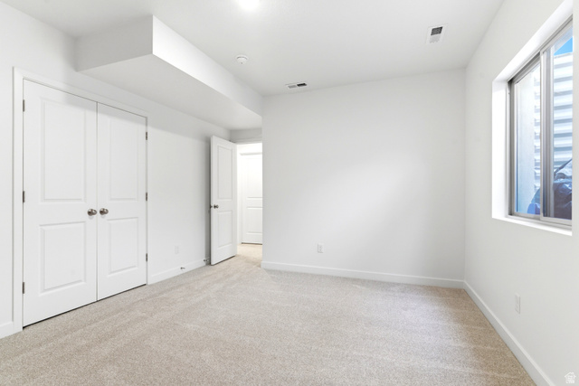 7243 West Terraine Road West Jordan, UT 84081 - Photo 22 of 31 Spacious room featuring light-toned carpeting, white walls, and a large window