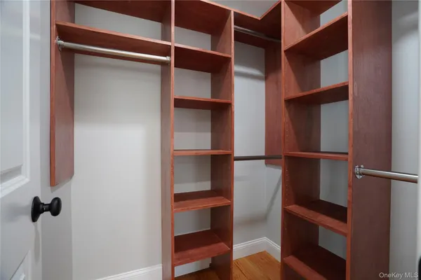a view of walk in closet with empty racks