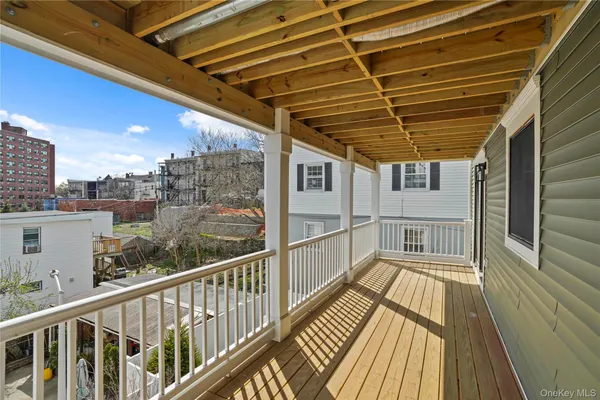 a view of a balcony with wooden floor