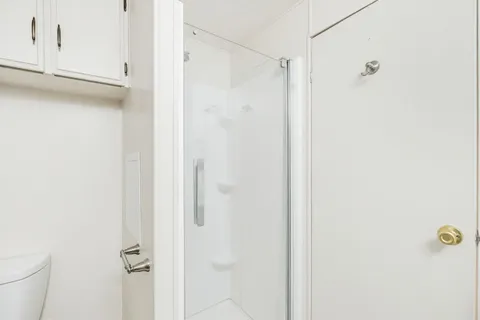 a bedroom with a bed and a dresser in it