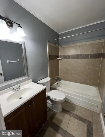 a bathroom with a double vanity sink toilet and shower