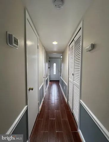 a view of gallery with wooden floor