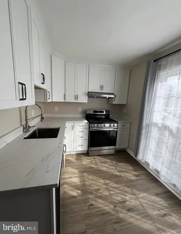 a kitchen with stainless steel appliances a stove a sink and a refrigerator