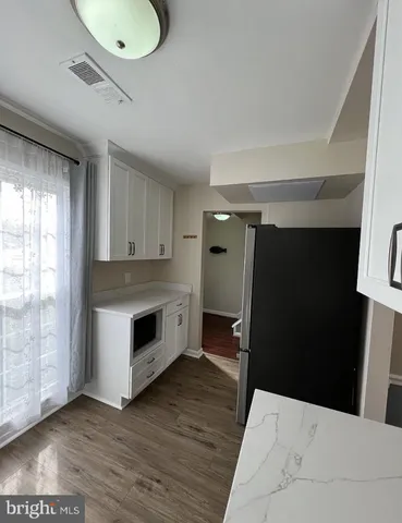 a kitchen with a refrigerator and window