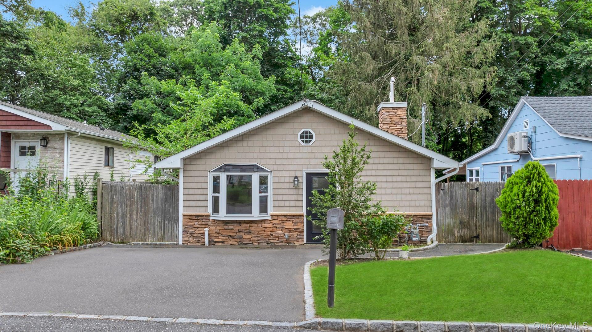 30 Harding Road Ronkonkoma, NY 11779 - Photo 1 of 38 a front view of a house with a yard and garage