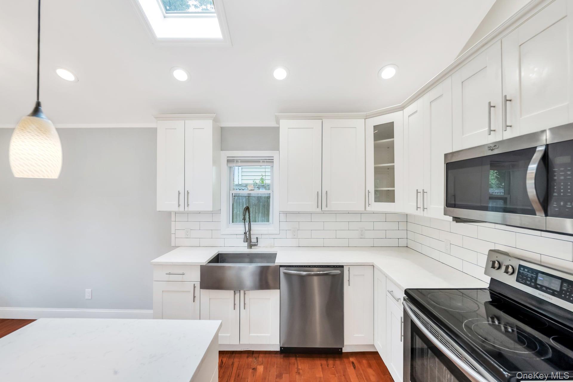 30 Harding Road Ronkonkoma, NY 11779 - Photo 11 of 38 a kitchen with a sink and a stove top oven