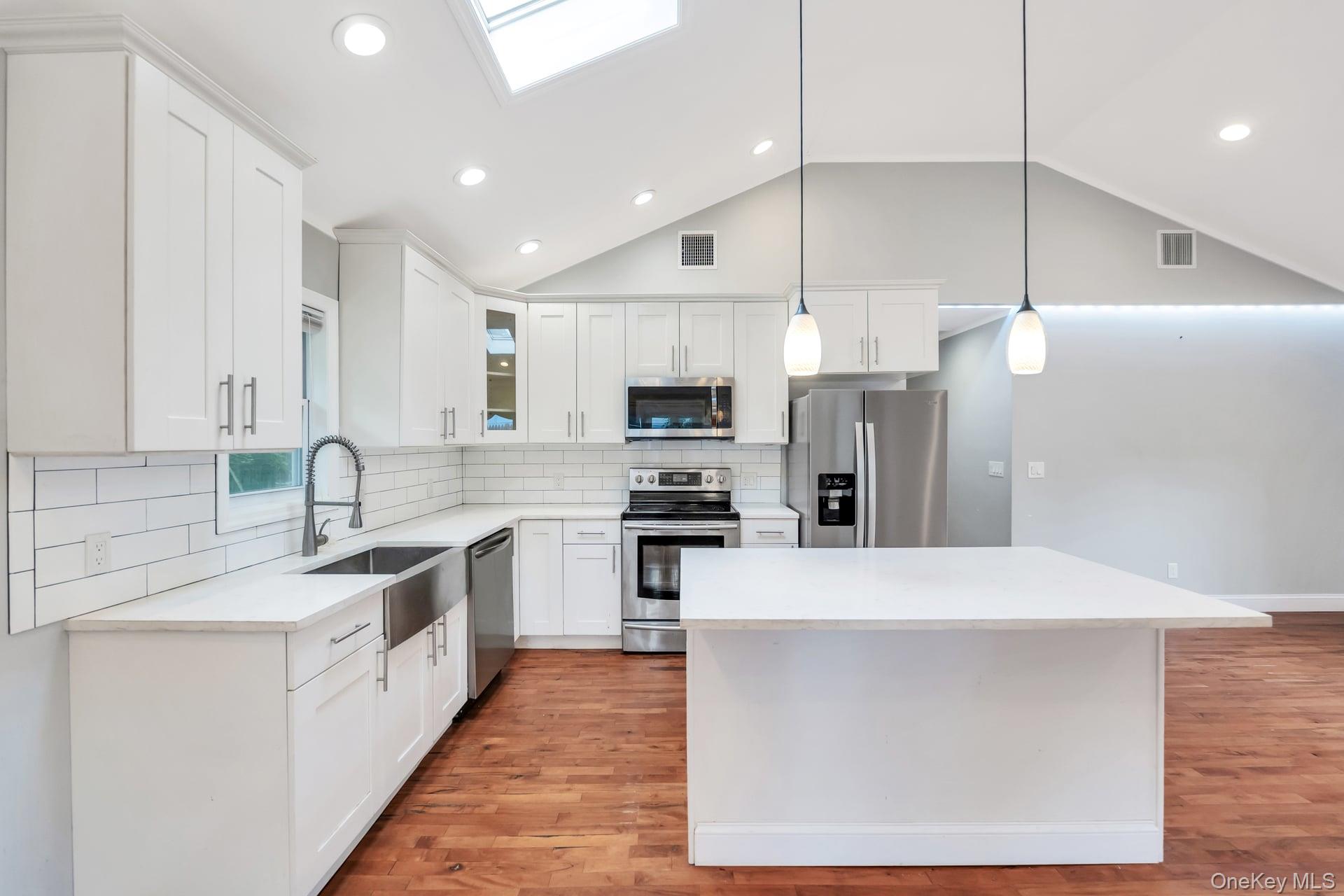 30 Harding Road Ronkonkoma, NY 11779 - Photo 12 of 38 a large kitchen with stainless steel appliances kitchen island a cabinets and a counter top space