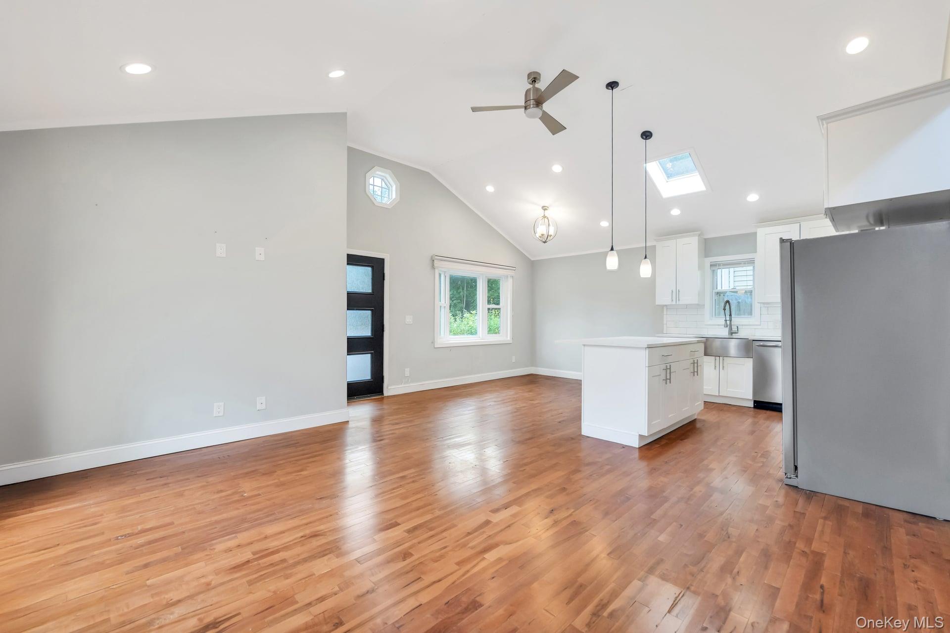 30 Harding Road Ronkonkoma, NY 11779 - Photo 16 of 38 a view of an empty room with wooden floor and a kitchen
