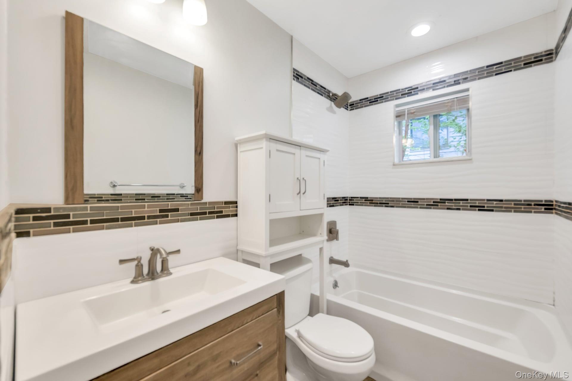 30 Harding Road Ronkonkoma, NY 11779 - Photo 19 of 38 a bathroom with a granite countertop sink mirror toilet and bathtub