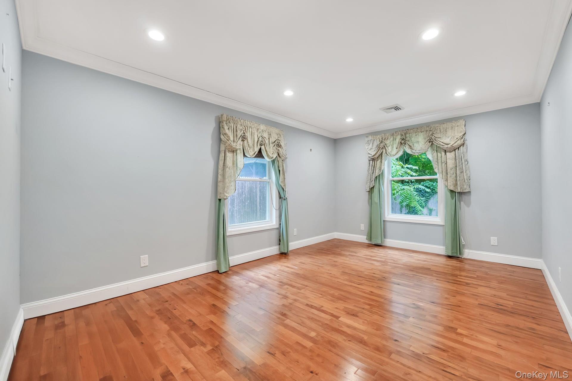 30 Harding Road Ronkonkoma, NY 11779 - Photo 21 of 38 wooden floor in an empty room with a window