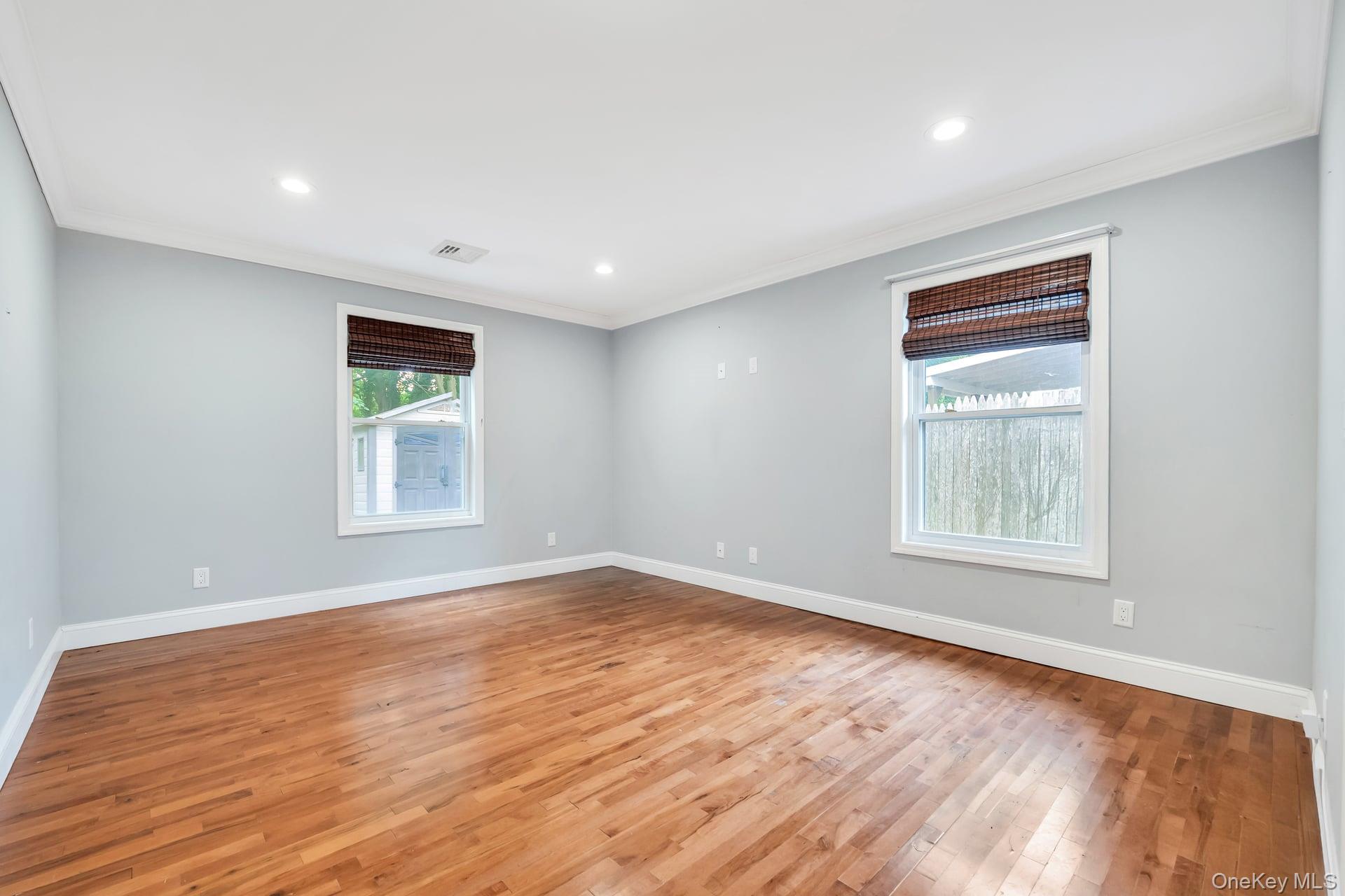 30 Harding Road Ronkonkoma, NY 11779 - Photo 25 of 38 an empty room with wooden floor and windows