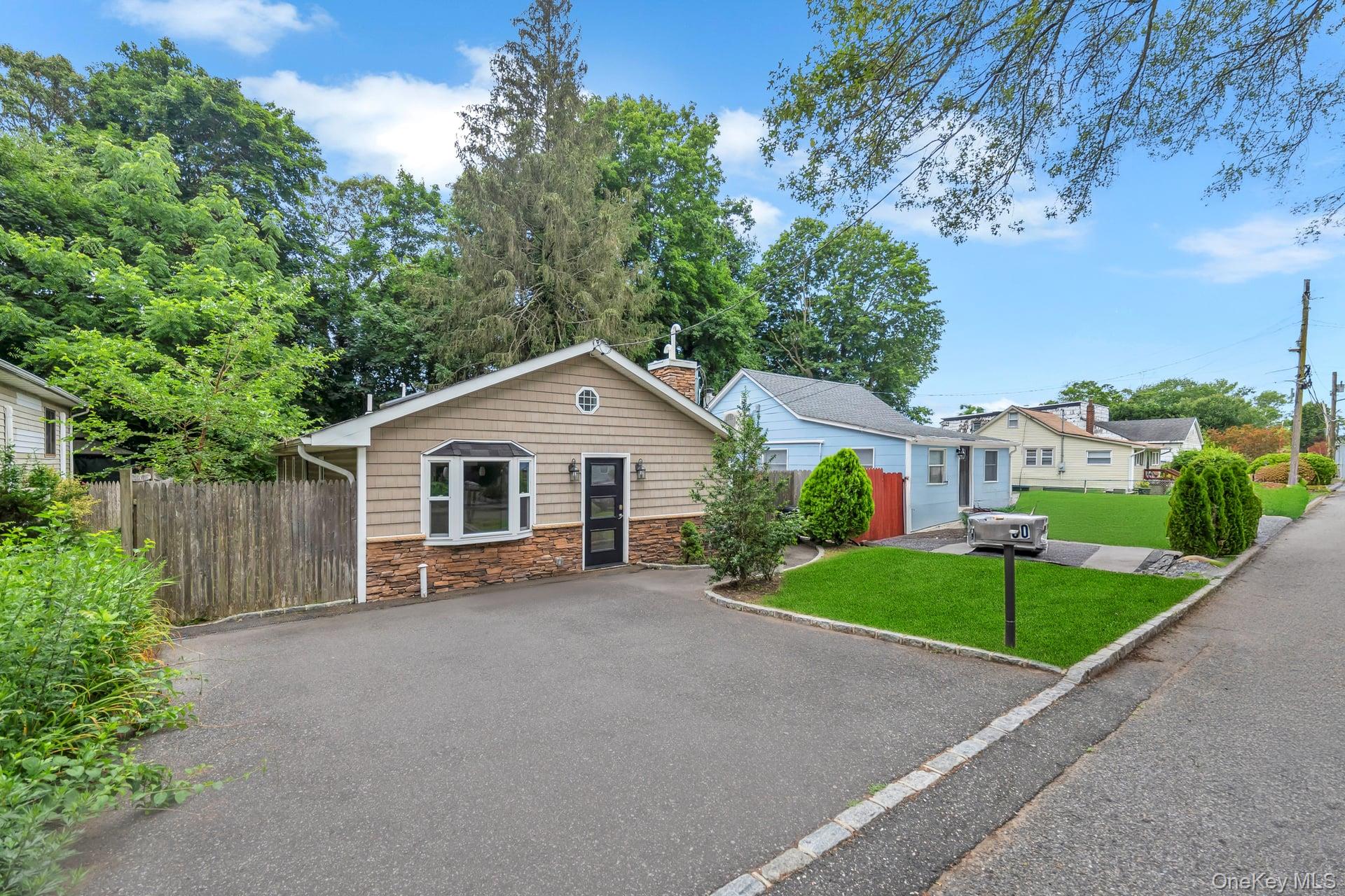 30 Harding Road Ronkonkoma, NY 11779 - Photo 3 of 38 a view of a house with a yard and potted plants