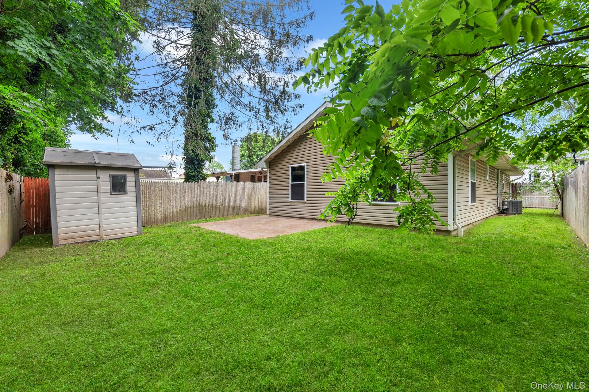 30 Harding Road Ronkonkoma, NY 11779 - Photo 34 of 38 a view of a house with a yard