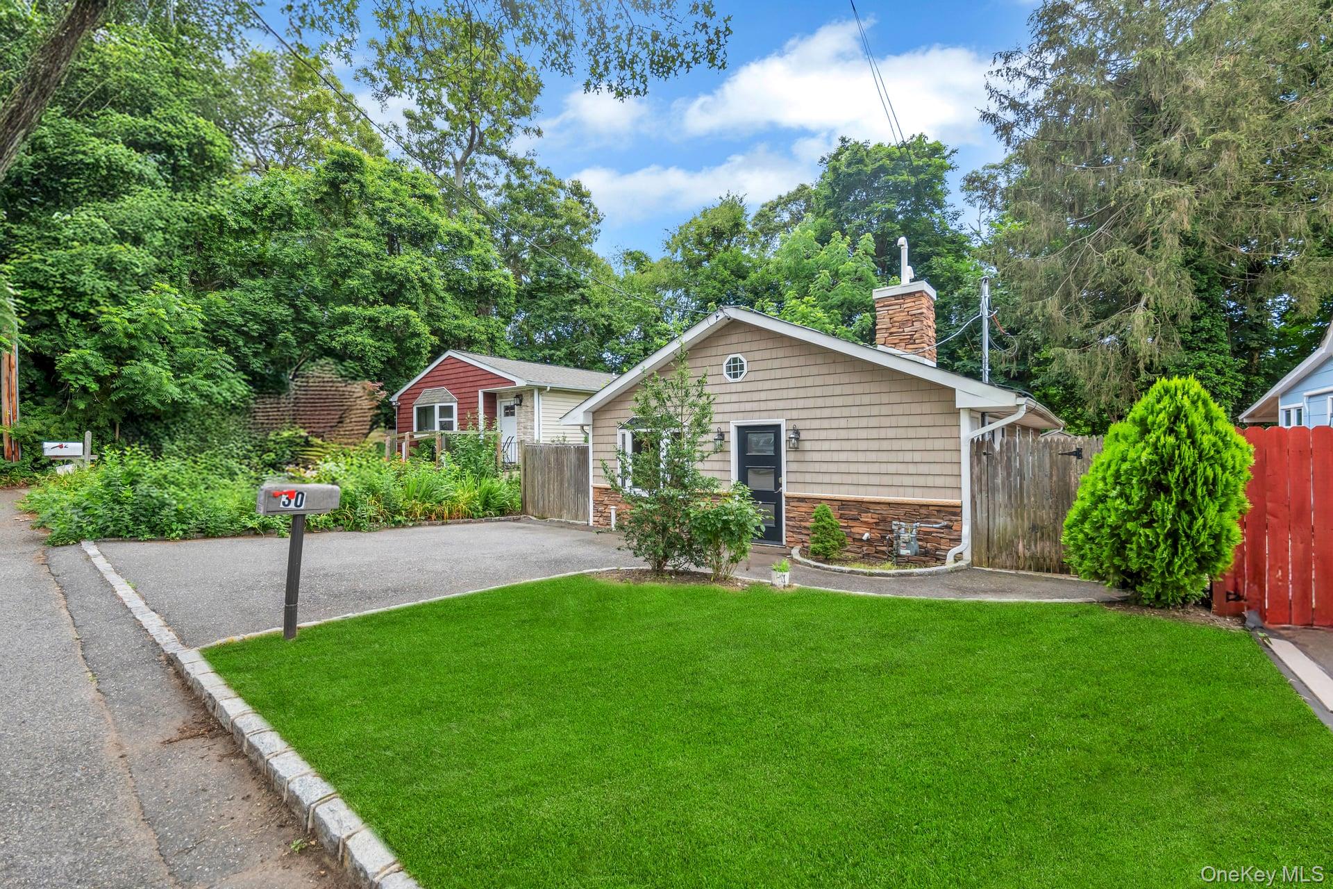 30 Harding Road Ronkonkoma, NY 11779 - Photo 38 of 38 a front view of house with a garden and patio