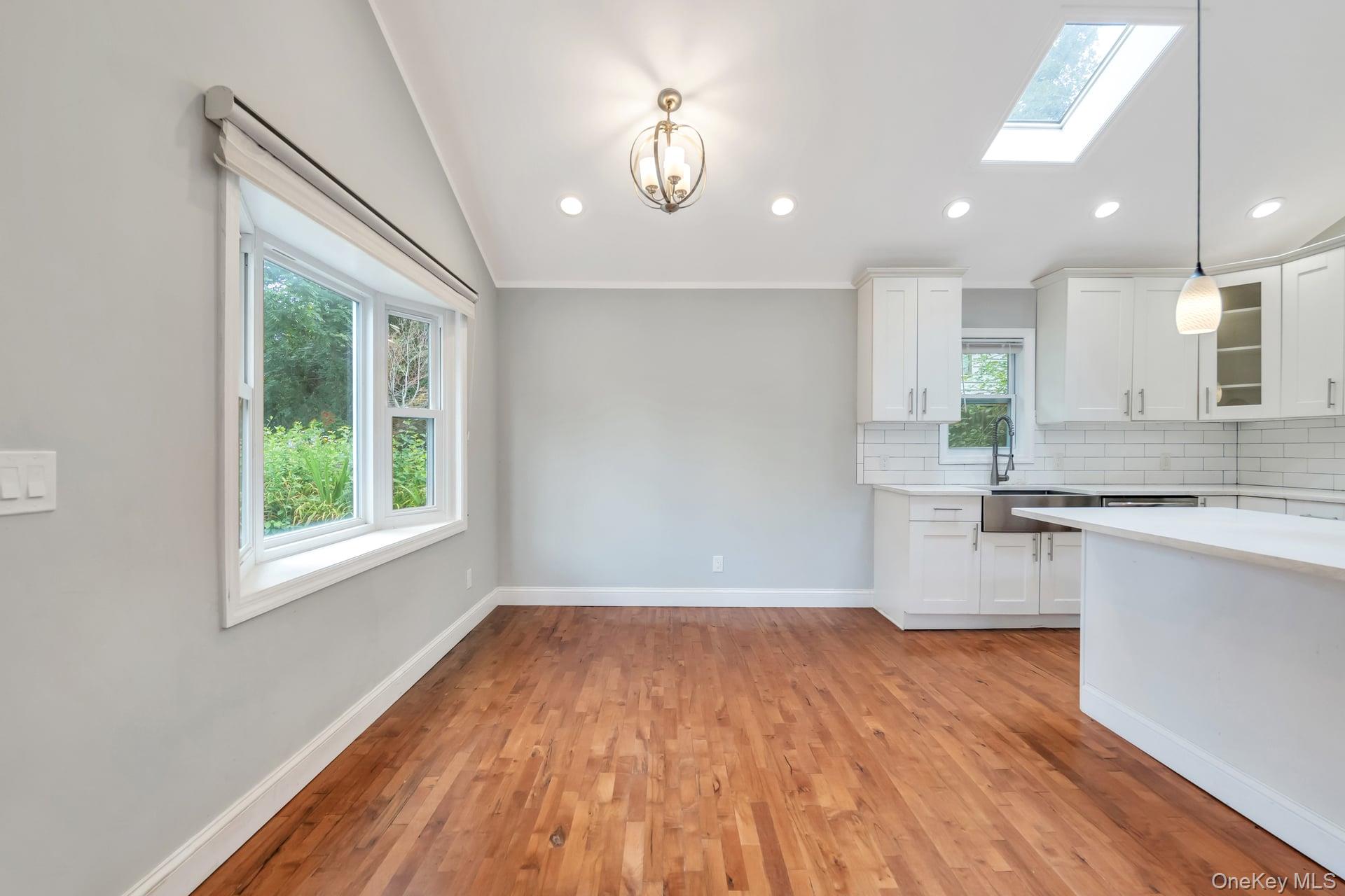 30 Harding Road Ronkonkoma, NY 11779 - Photo 7 of 38 a open kitchen with kitchen island white cabinets and wooden floor