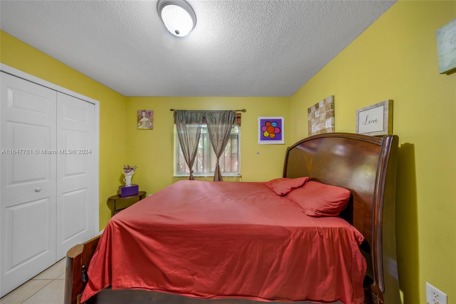 12431 Southwest 220th Street Miami, FL 33170 - Photo 12 of 34 a bed sitting in a bedroom next to a window