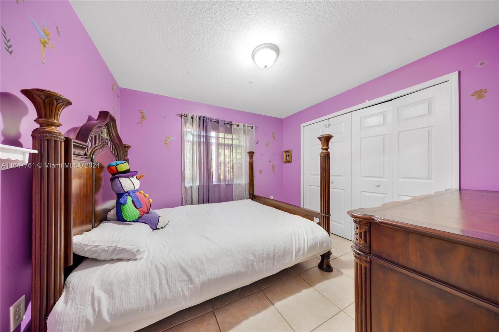 12431 Southwest 220th Street Miami, FL 33170 - Photo 14 of 34 a bedroom with a bed and a closet