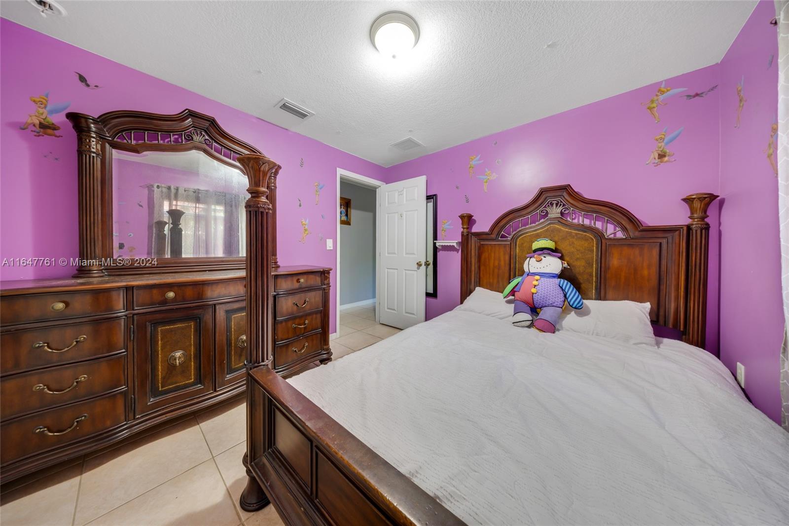 12431 Southwest 220th Street Miami, FL 33170 - Photo 15 of 34 a bedroom with a bed and a dresser