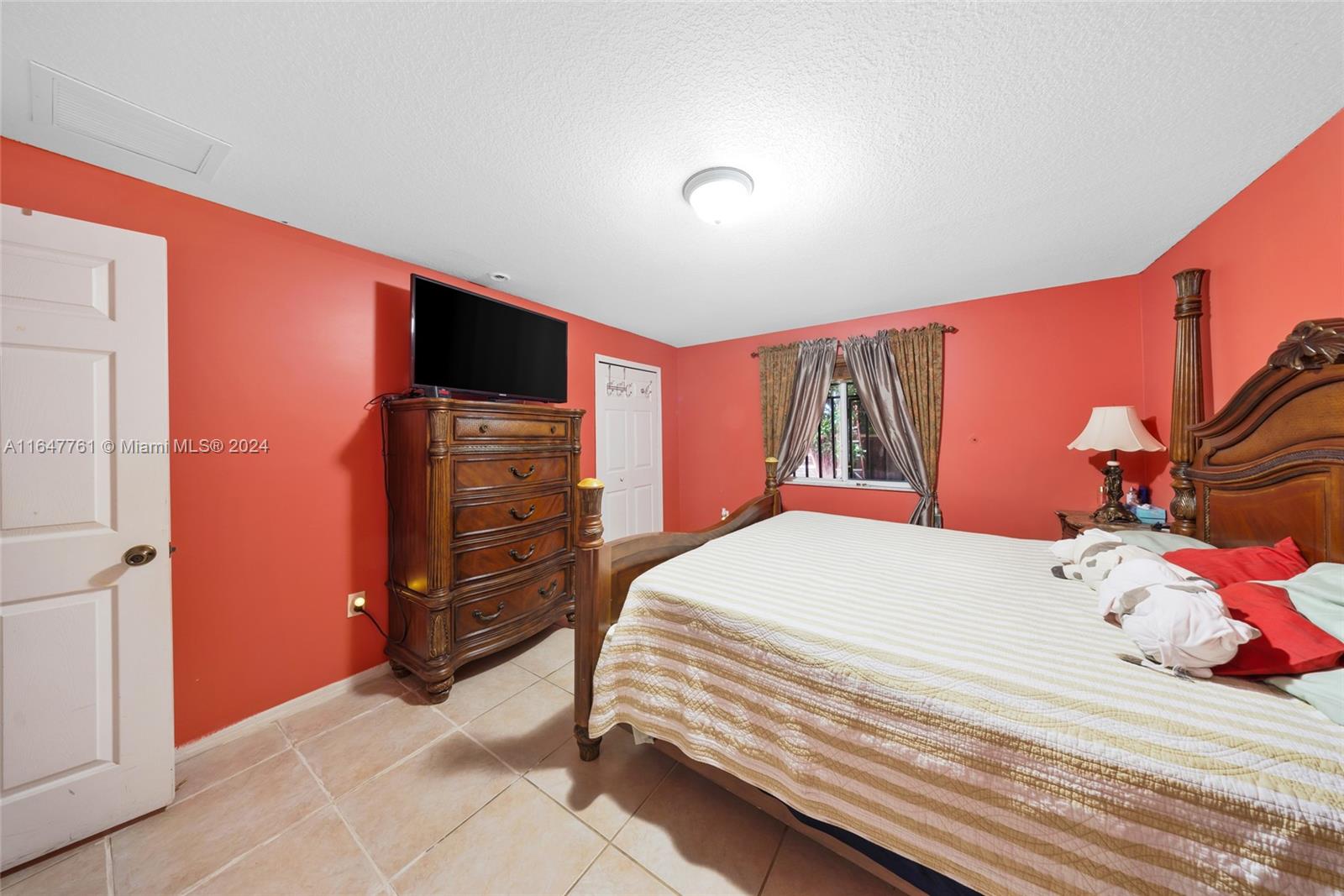 12431 Southwest 220th Street Miami, FL 33170 - Photo 18 of 34 a bedroom with a bed and a closet
