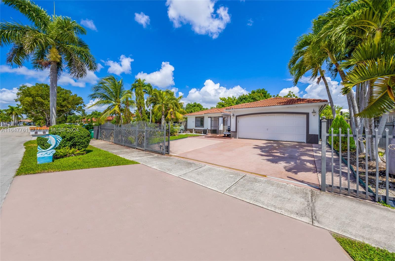 12431 Southwest 220th Street Miami, FL 33170 - Photo 2 of 34 a view of a house with a yard and potted plants