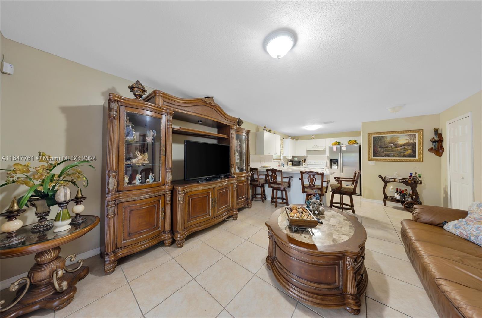 12431 Southwest 220th Street Miami, FL 33170 - Photo 25 of 34 a living room with furniture and a flat screen tv