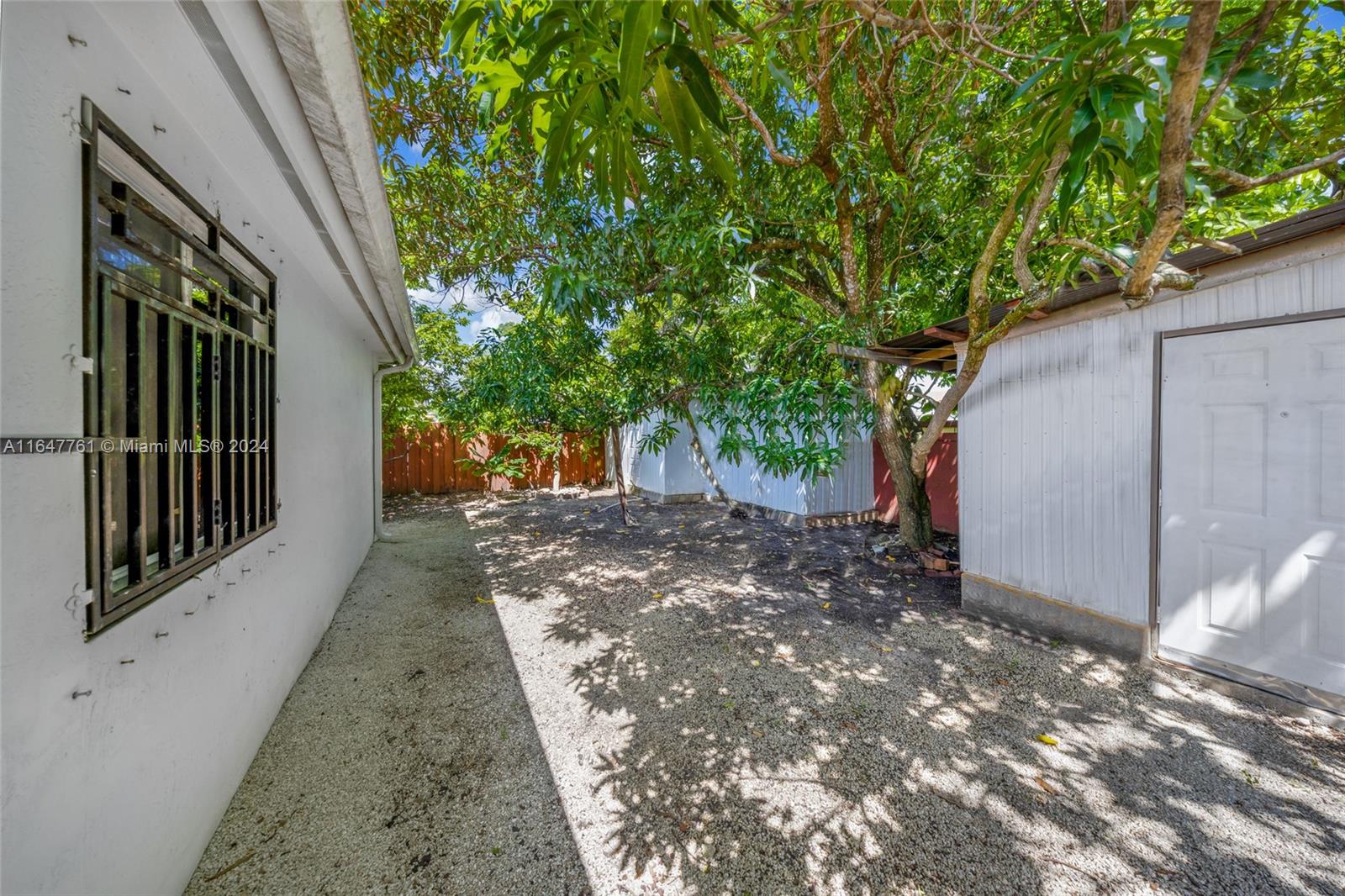 12431 Southwest 220th Street Miami, FL 33170 - Photo 30 of 34 a view of a house with a backyard