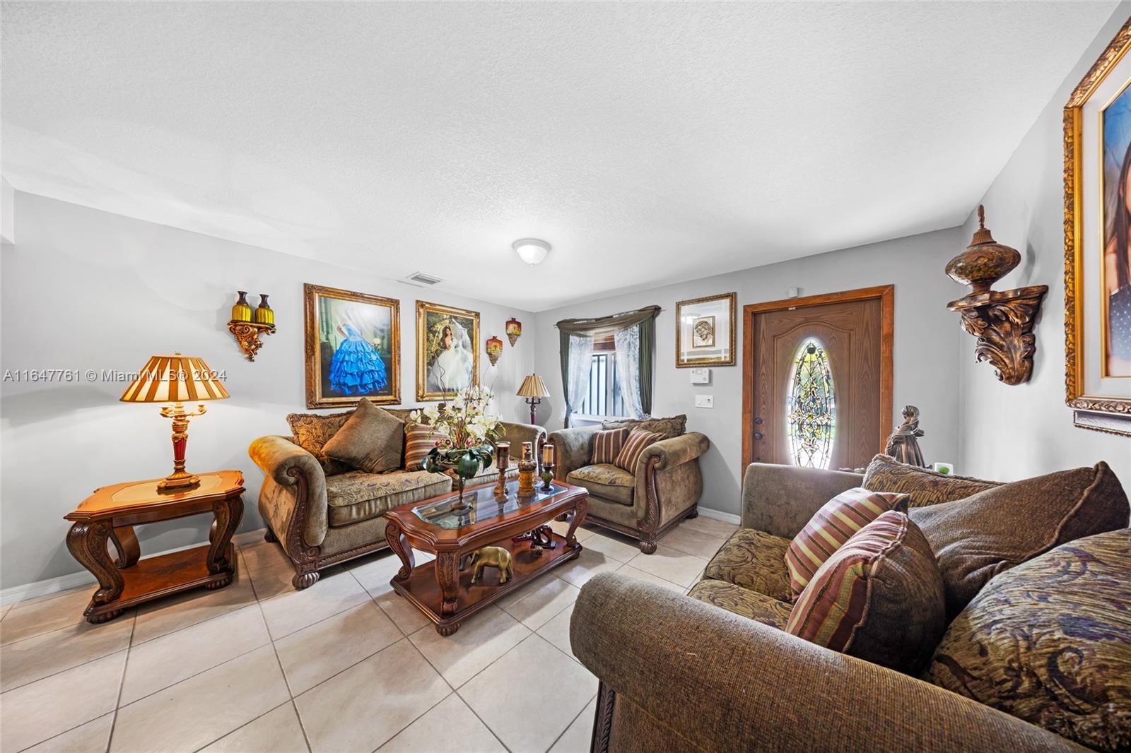 12431 Southwest 220th Street Miami, FL 33170 - Photo 4 of 34 a living room with furniture and a window