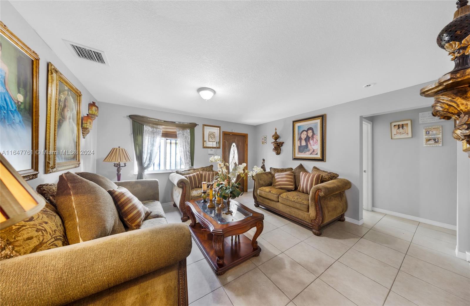 12431 Southwest 220th Street Miami, FL 33170 - Photo 5 of 34 a living room with furniture and a window