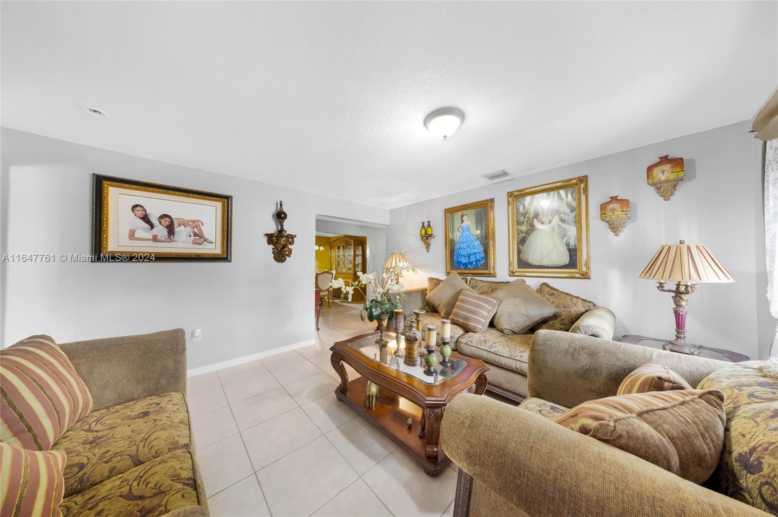 12431 Southwest 220th Street Miami, FL 33170 - Photo 6 of 34 a living room with furniture and a lamp
