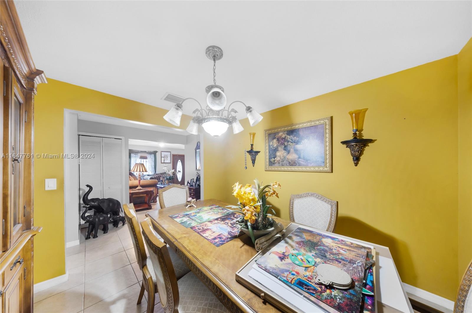 12431 Southwest 220th Street Miami, FL 33170 - Photo 8 of 34 a view of a dining room with furniture and a chandelier