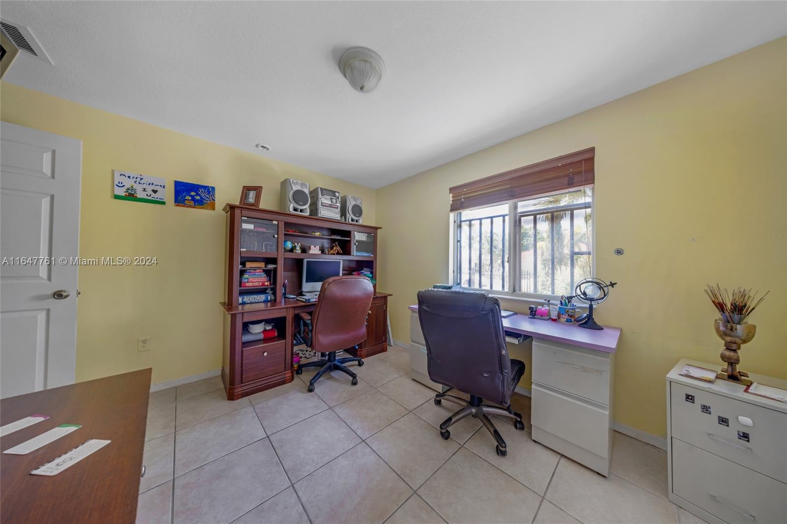 12431 Southwest 220th Street Miami, FL 33170 - Photo 9 of 34 a view of a workspace with furniture and a window