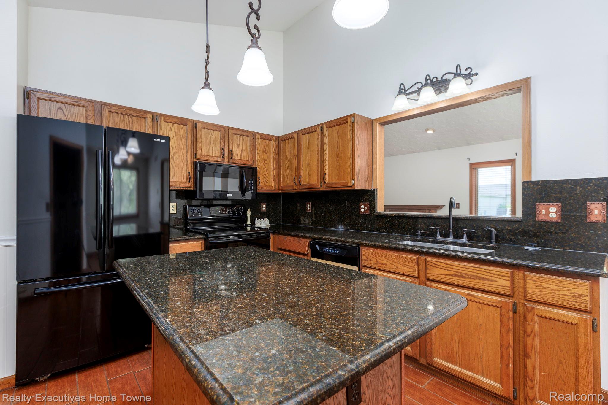 1041 Mackie Road Almont, MI 48003 - Photo 28 of 56 Kitchen featuring black appliances, a kitchen island, wood finish cabinets, pendant lighting, and wood finish floors