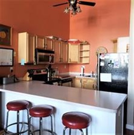 63 Blakeley Street, Unit 203 Woonsocket, RI 02895 - Photo 8 of 16 a kitchen with stainless steel appliances granite countertop a sink a stove and a wooden floors