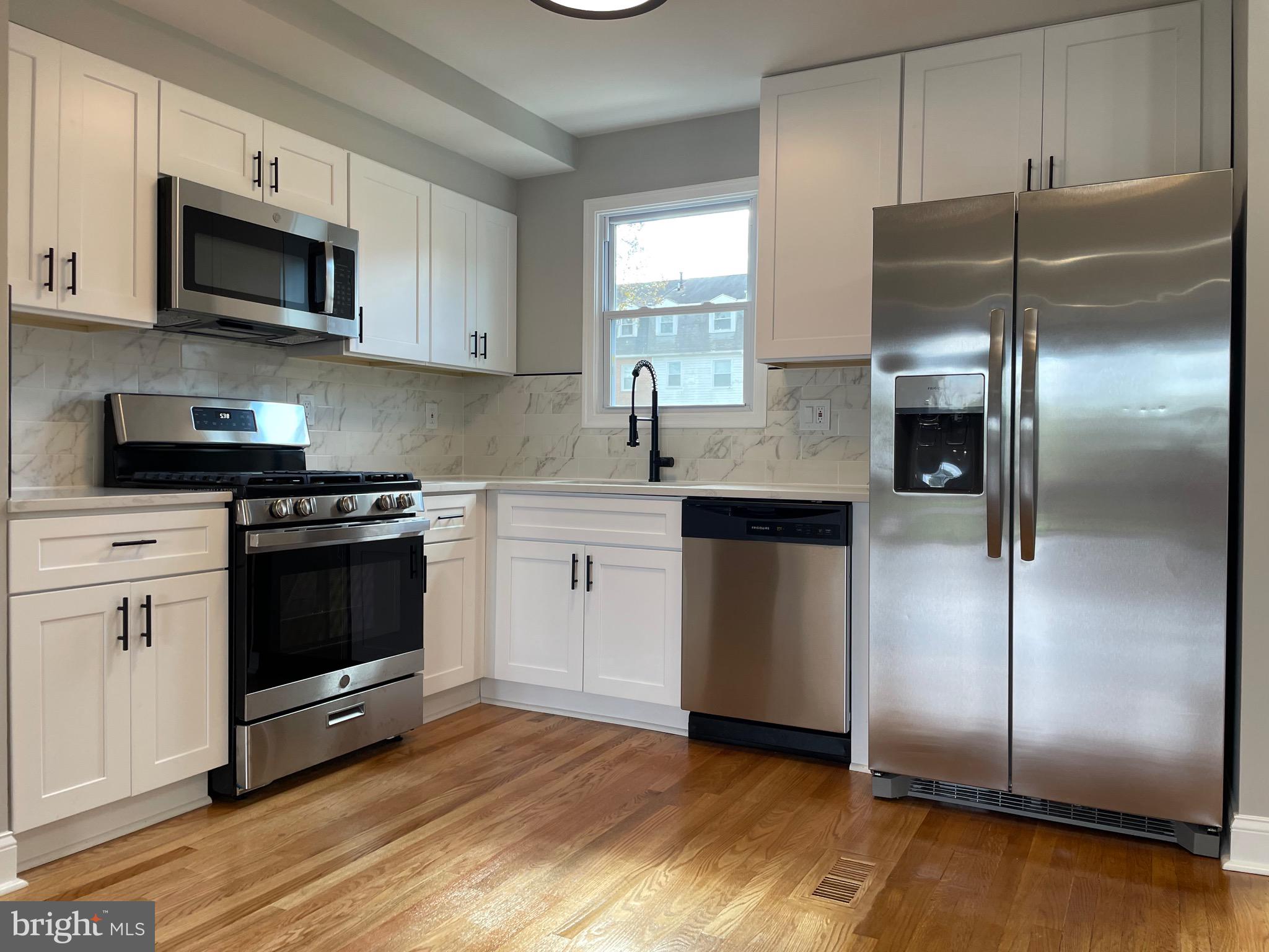 a kitchen with a refrigerator stove and microwave