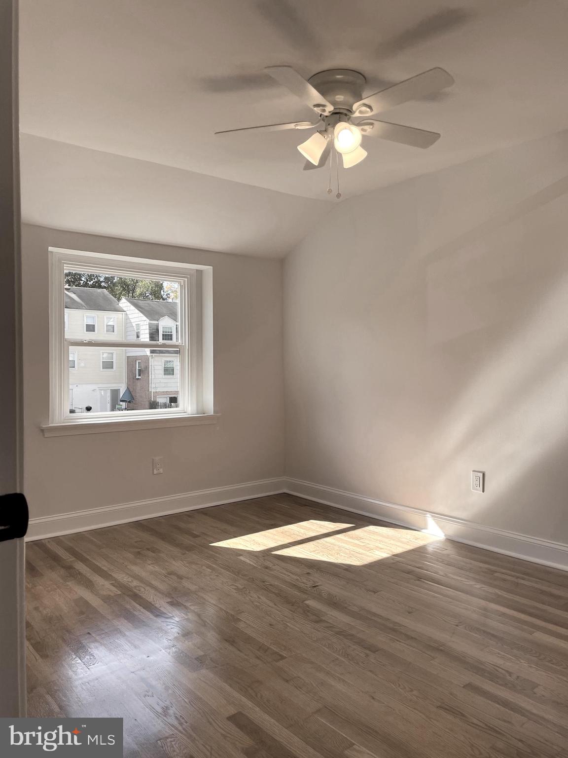 136 Old Enterprise Road, Unit 131 Upper Marlboro, MD 20774 - Photo 11 of 36 an empty room with wooden floor chandelier fan and windows