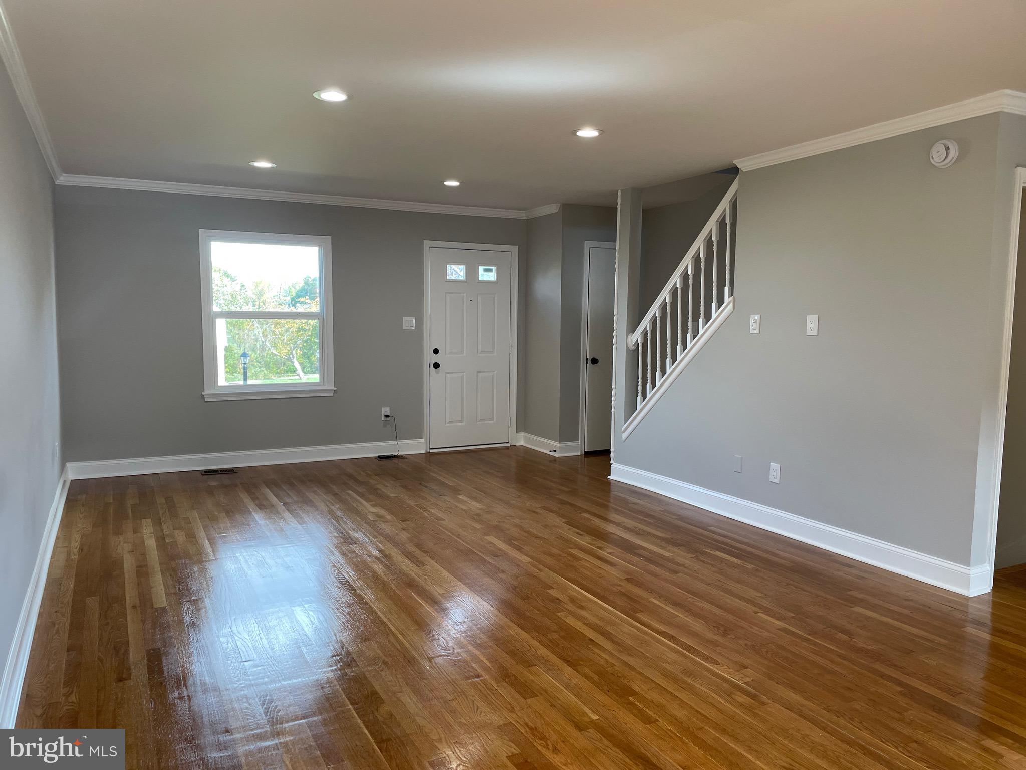 136 Old Enterprise Road, Unit 131 Upper Marlboro, MD 20774 - Photo 19 of 36 a view of an empty room with wooden floor and a window