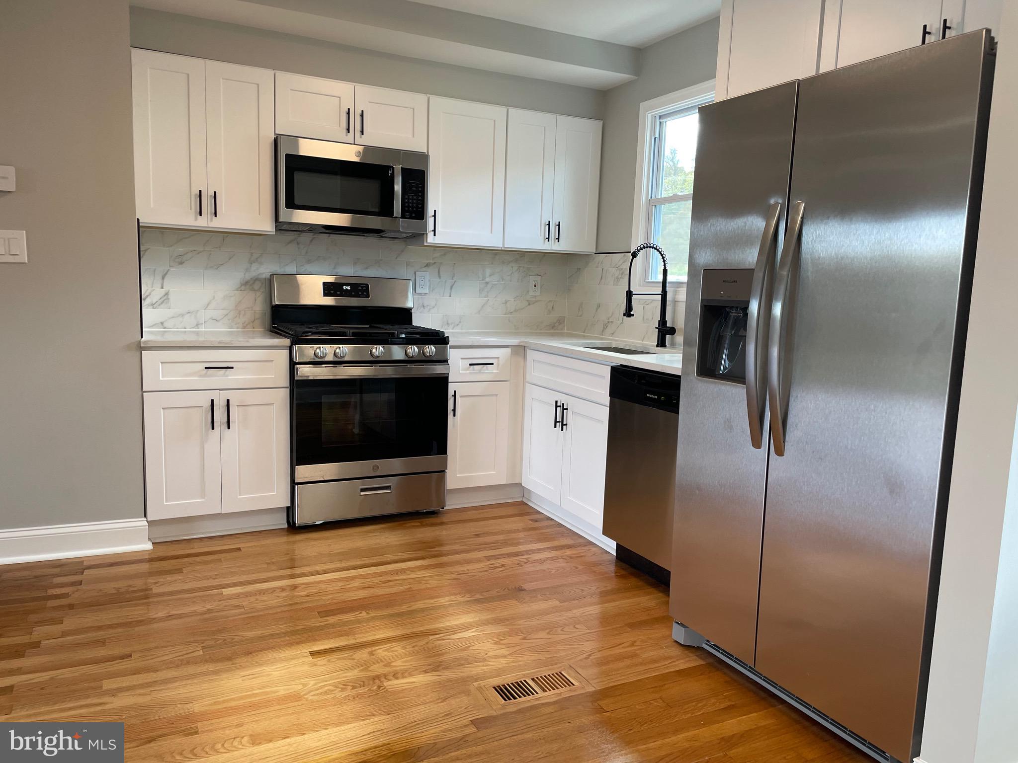136 Old Enterprise Road, Unit 131 Upper Marlboro, MD 20774 - Photo 3 of 36 a kitchen with stainless steel appliances granite countertop a stove a refrigerator and a microwave