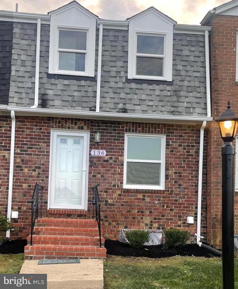136 Old Enterprise Road, Unit 131 Upper Marlboro, MD 20774 - Photo 34 of 36 a front view of a house with a yard