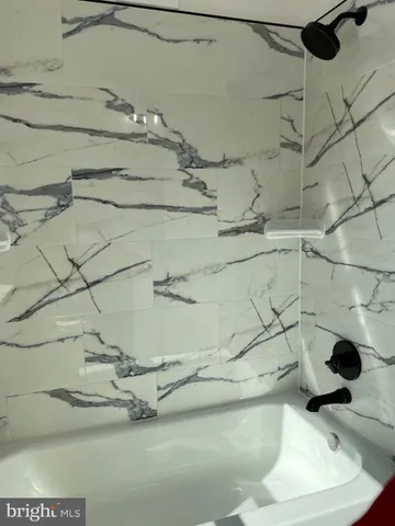 a dirty bathroom with a bathtub