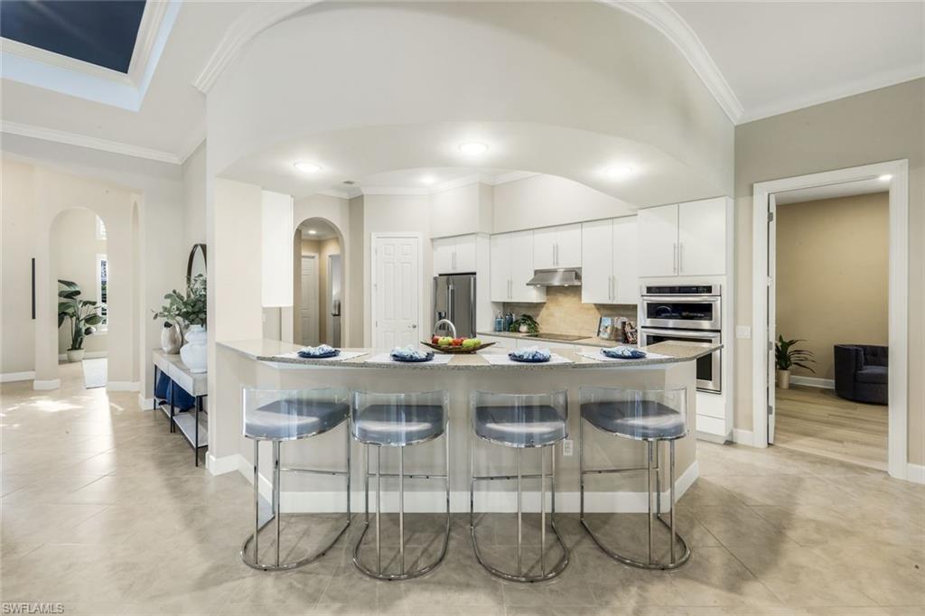 9314 Quarry Drive Naples, FL 34120 - Photo 13 of 49 a kitchen with a table and chairs in it