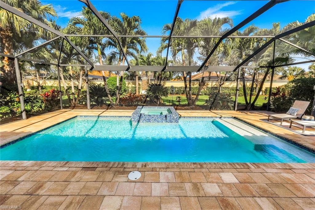9314 Quarry Drive Naples, FL 34120 - Photo 3 of 49 a view of a swimming pool with an outdoor space and seating area