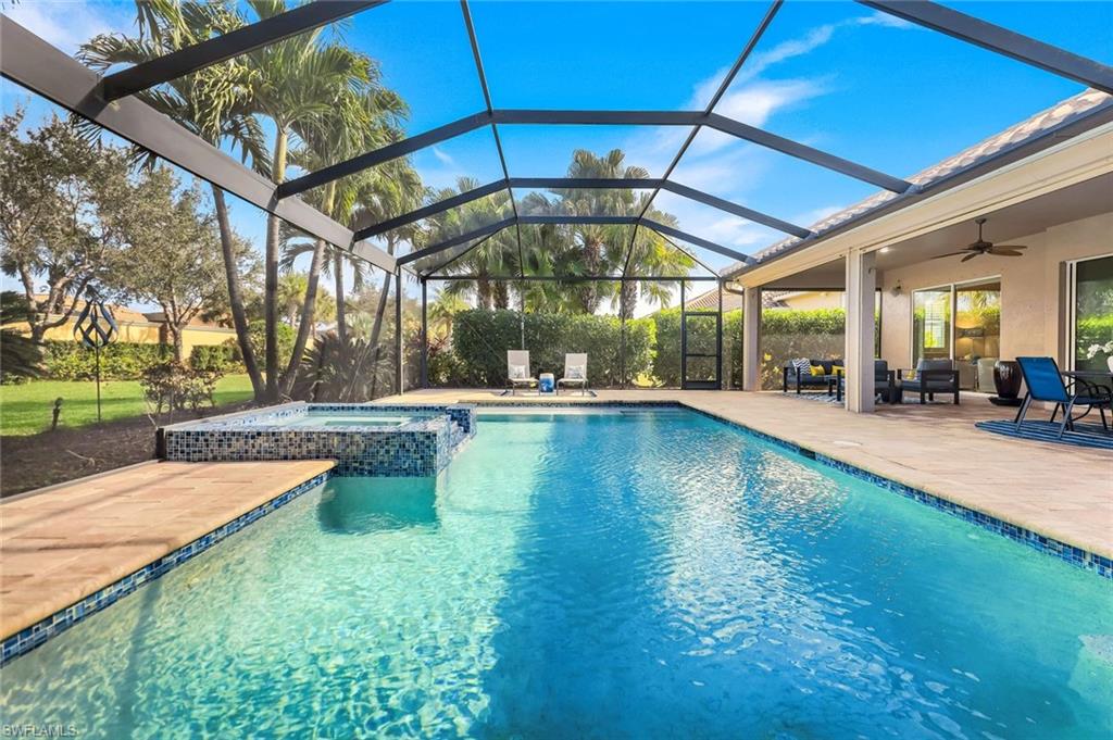 9314 Quarry Drive Naples, FL 34120 - Photo 31 of 49 a view of a swimming pool with a patio