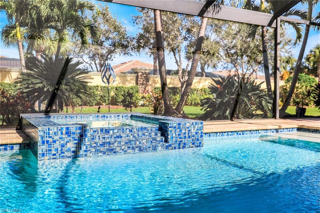 9314 Quarry Drive Naples, FL 34120 - Photo 33 of 49 a view of outdoor space with a garden and trees