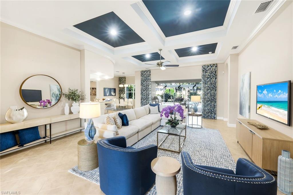 9314 Quarry Drive Naples, FL 34120 - Photo 7 of 49 a living room with furniture and a flat screen tv