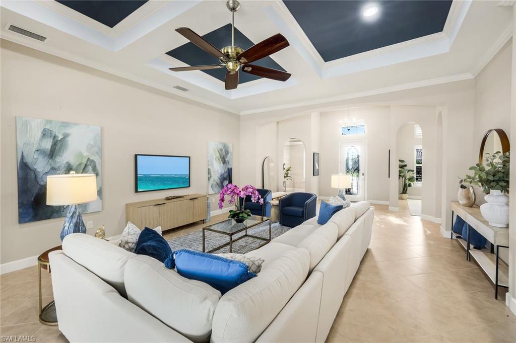 9314 Quarry Drive Naples, FL 34120 - Photo 8 of 49 a living room with furniture and a chandelier