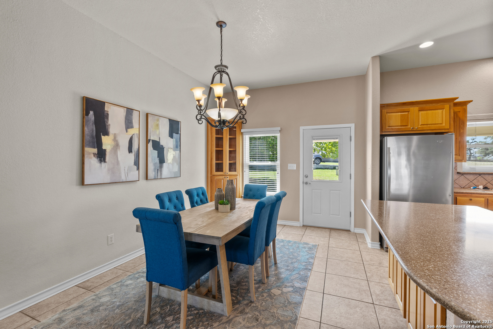 174 Edgewood Circle Bandera, TX 78003 - Photo 19 of 33 a view of a dining room with furniture a chandelier and wooden floor
