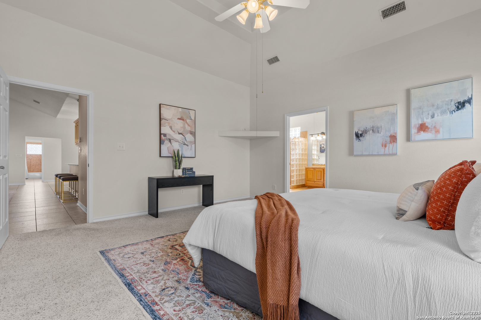 174 Edgewood Circle Bandera, TX 78003 - Photo 21 of 33 a bedroom with a bed and a chandelier
